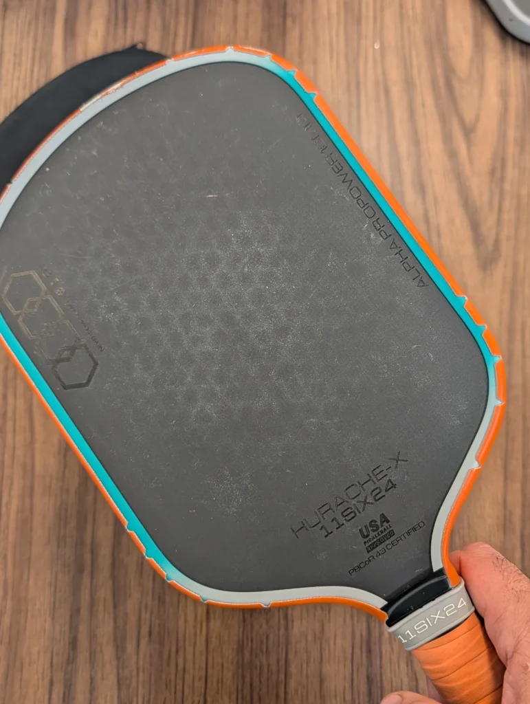 Macro view of the 11six24 Alpha Pro Power paddle's 10mm core construction, which Coach Sid Parfait found provides superior dwell time for advanced shot shaping.