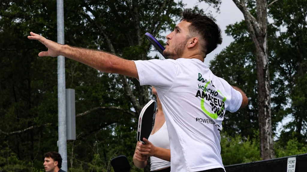 AJ Parfait reaching for a difficult pickleball shot during tournament play.