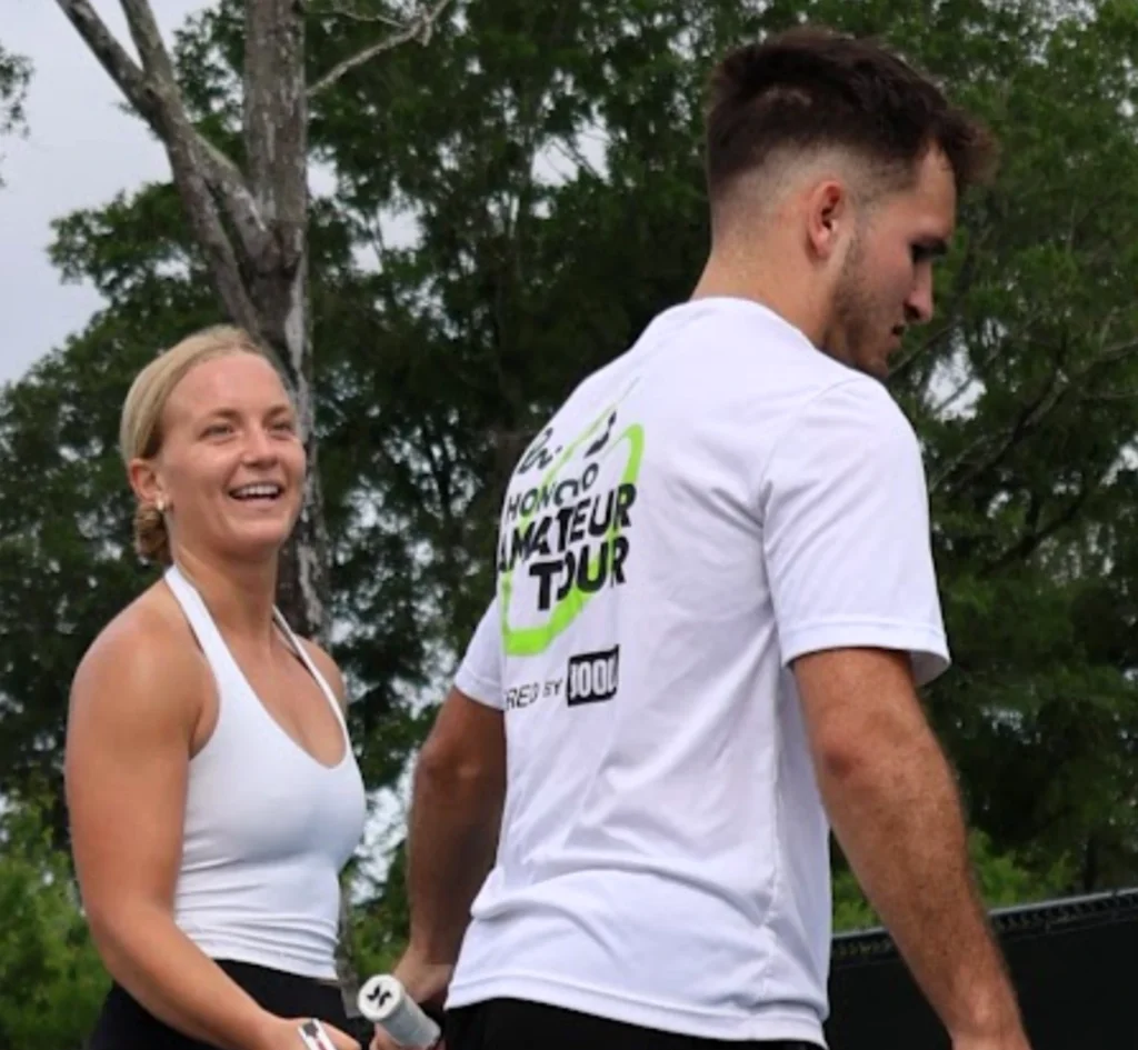 AJ Parfait and his partner sharing a light moment during the Hattiesburg Moneyball pickleball tournament.
