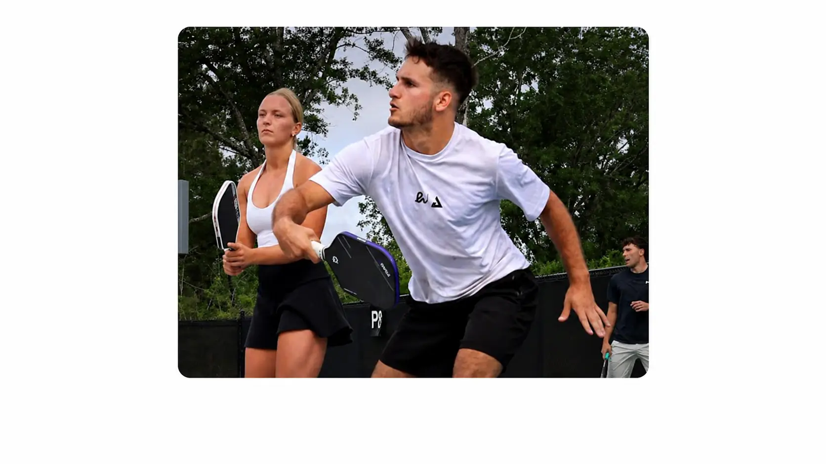 AJ Parfait focused and reacting during a competitive pickleball point at the Hattiesburg Moneyball tournament.