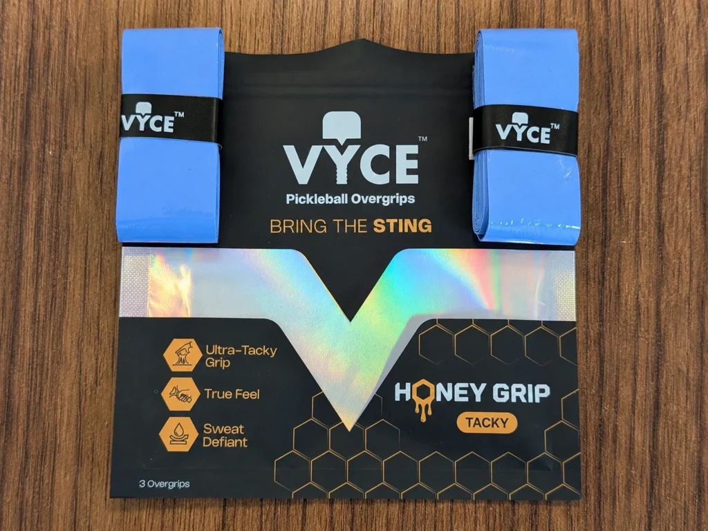 Real photo of VYCE Honey Grip tacky pickleball overgrips in Steel Blue packaging for the PickleTip review.