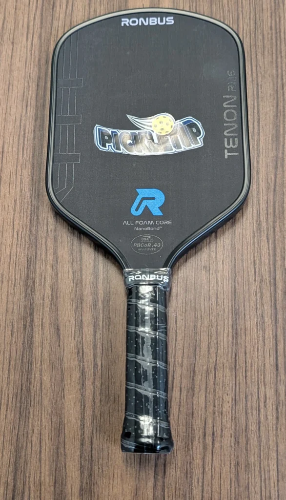 Ronbus Tenon R1.16 pickleball paddle with a PickleTip sticker placed on the paddle face